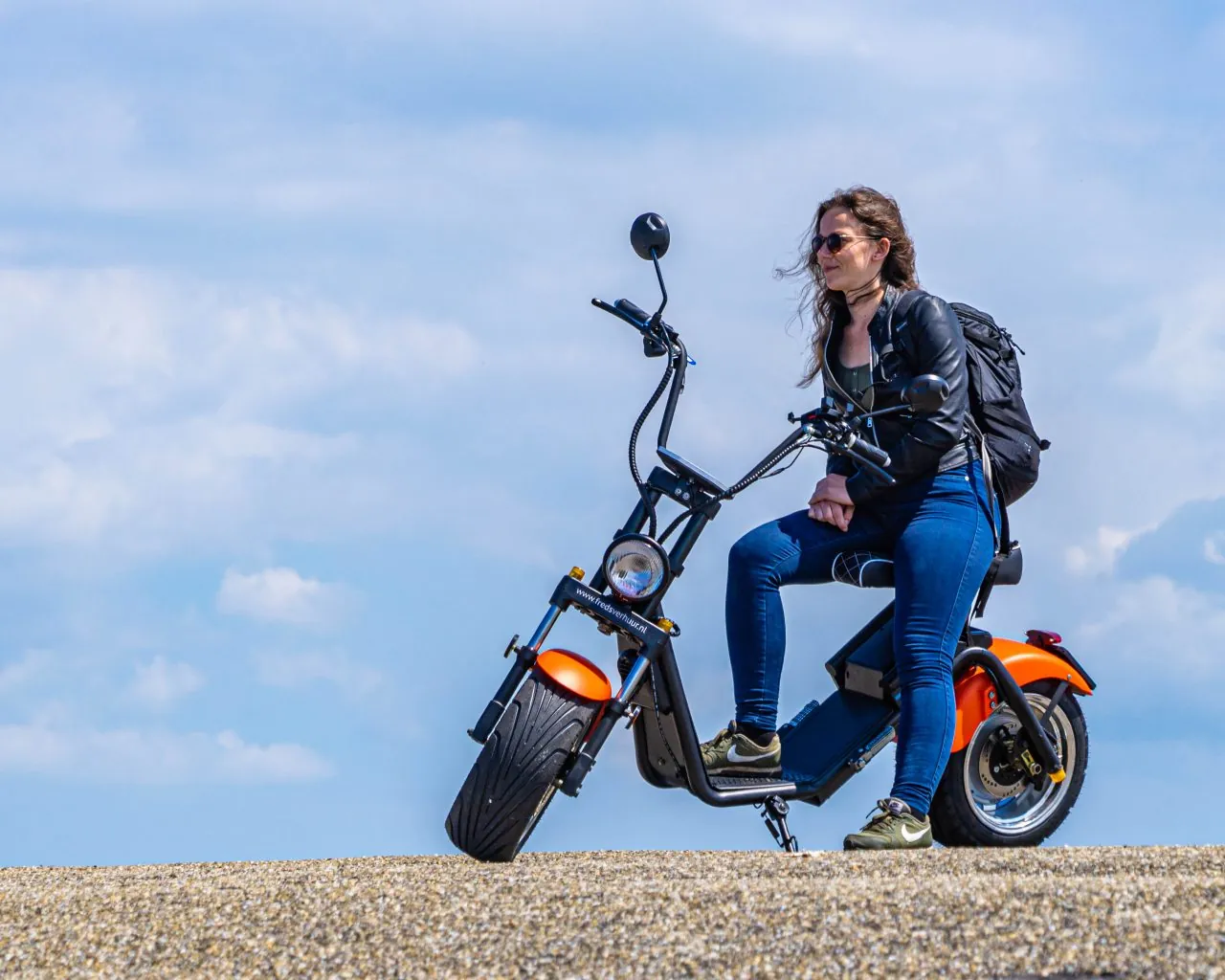 Woman on a Fred’s Verhuur E-Chopper on the dyke near Schagen